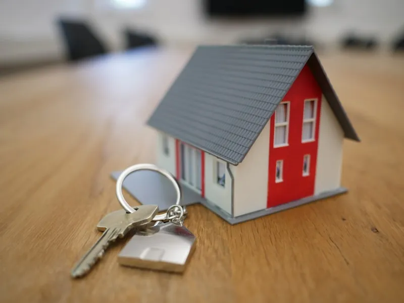 Close-up of a house key on a modern wooden table